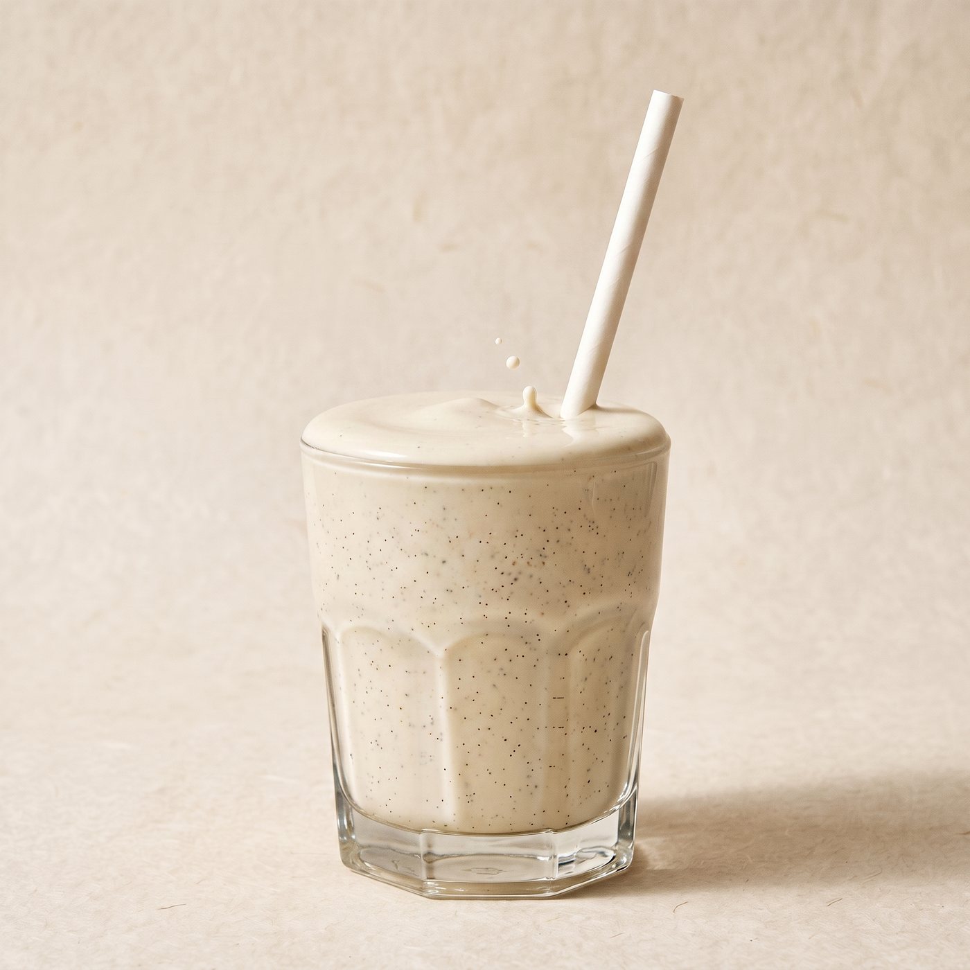 Thickshake mixed with more liquid - lighter, with a straw